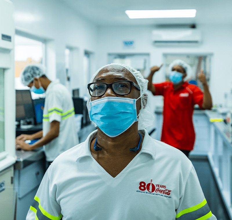 A female nurse in the hospital with in the background 2 more nurses