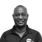 Jersley ‘Nicolaas’ Martis smiling in a company polo shirt, representing the Coca-Cola Curaçao team with pride.