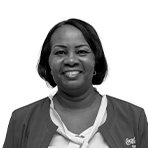 Linda Suares smiling in uniform, Coca-Cola Curaçao employee.
