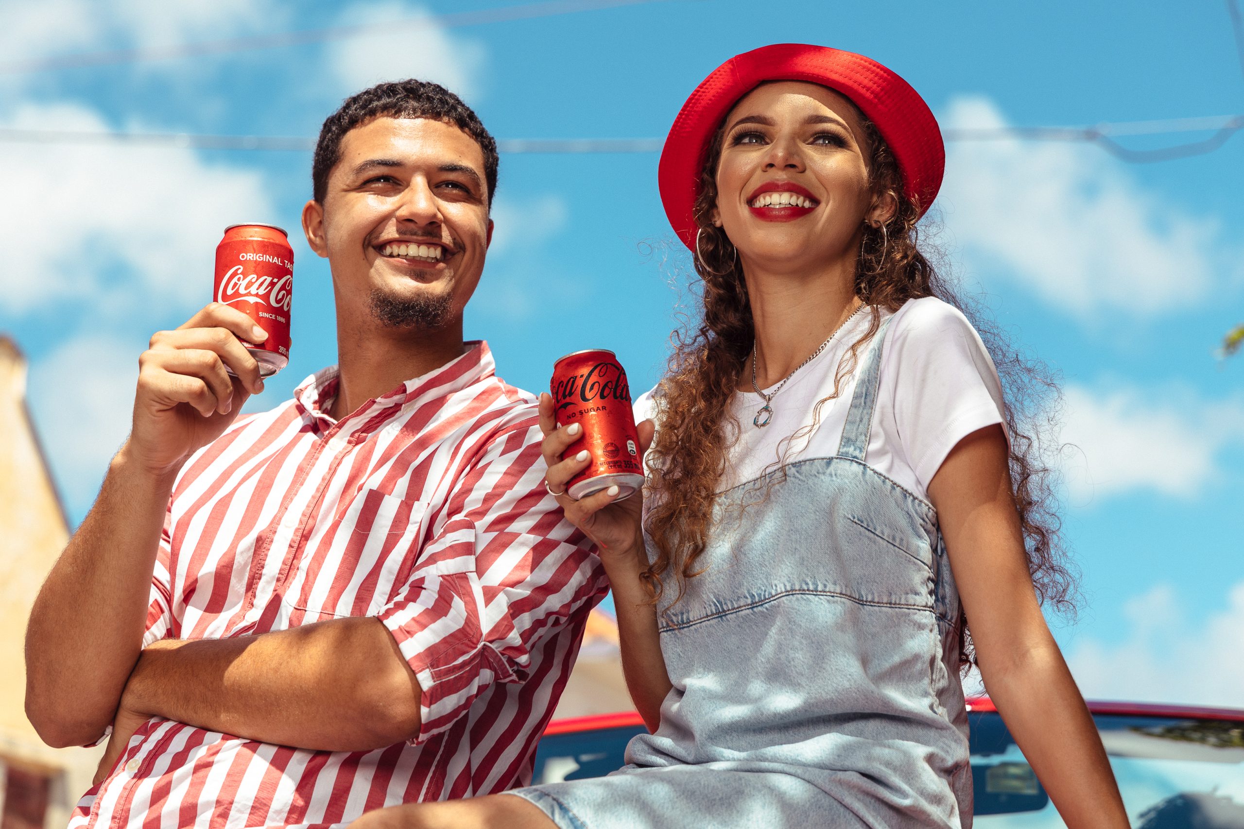 Coca-Cola employees in branded shirts participating in a recycling effort.