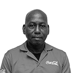Elwin Obispo in Coca-Cola Curacao shirt, standing firm as part of the reliable operations team.